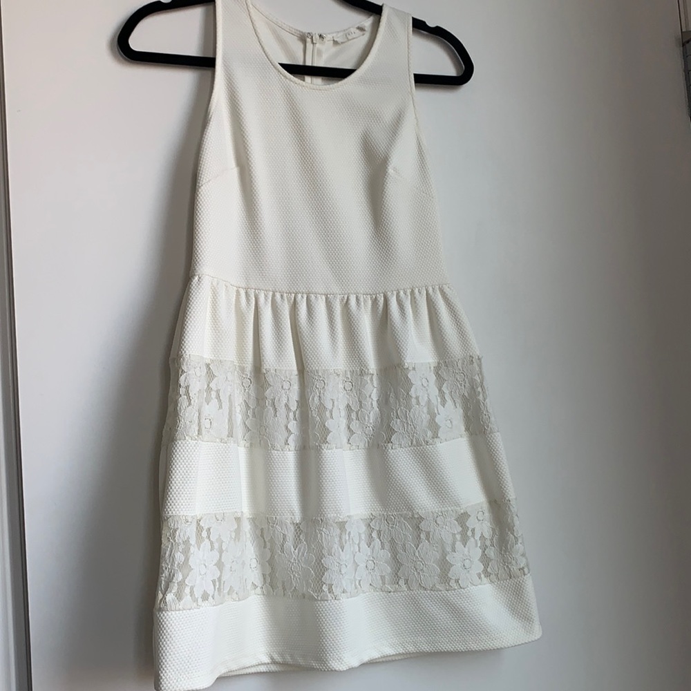 White sleeveless a line dress with lace detail
